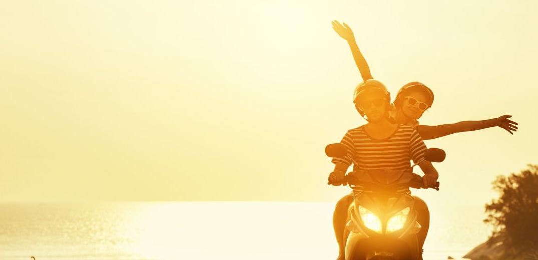 Two friends enjoying a motorcycle ride at sunset.